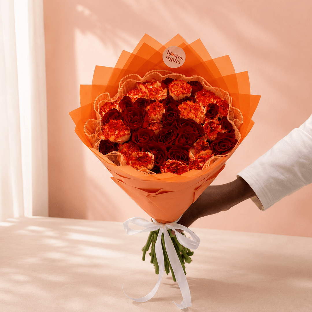 Blooms & Gifts Coral Sunset – Orange Carnation & Red Rose Bouquet