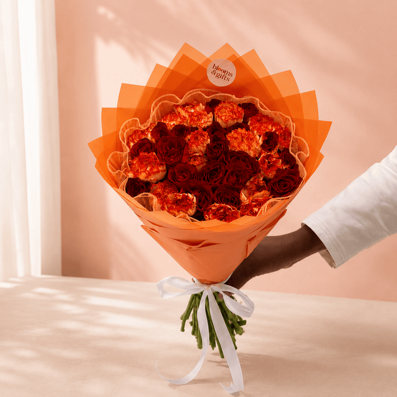 Blooms & Gifts Coral Sunset – Orange Carnation & Red Rose Bouquet
