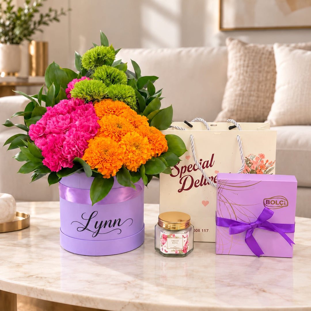 Blooms & Gifts Fiesta Marigold Pink Carnation & Marigold Round Box with Chocolates & Candle