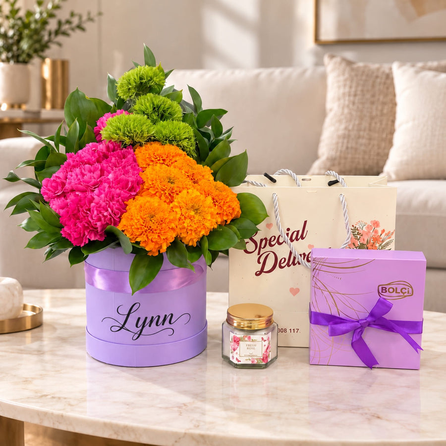 Blooms & Gifts Fiesta Marigold Pink Carnation & Marigold Round Box with Chocolates & Candle